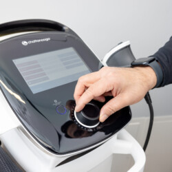 therapist adjusting shockwave machine